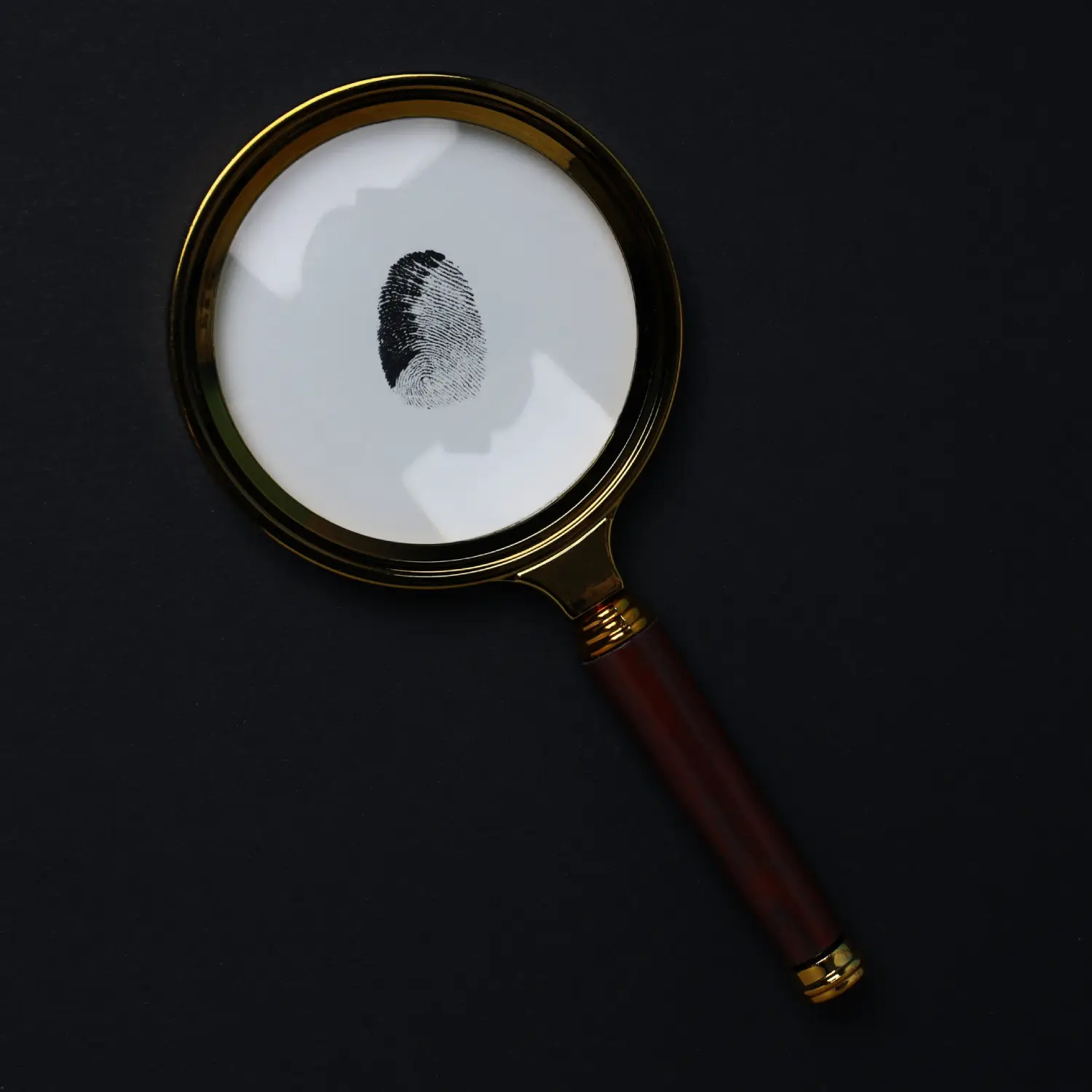 magnifying-glass-with-fingerprints-dark-background